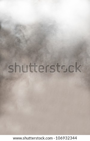 Dynamic background of thick clouds of grey and white swirling smoke from a burning fire or fog with an ethereal spiritual quality Royalty-Free Stock Photo #106932344