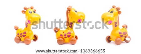 Three mechanical giraffe toy. Clockwork plastic toy isolated on white background.