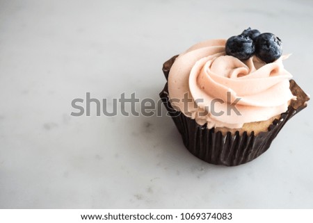 Vanilla cupcake with grape toping
