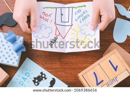 Fathers day composition with space for with child's drawing on wooden background