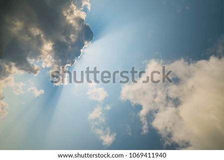 Sunbeam striking the clouds and blue sky in the morning