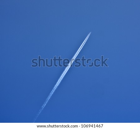 trail of white smoke from the airplane on blue sky