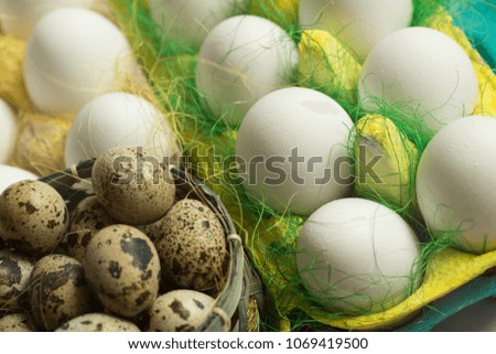 White chicken Chicken and quail eggs in colored paper eco-friendly packaging with decorative sisal. Close-up photo, macro.  Easter background. Food concept