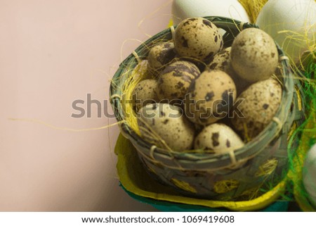 White chicken Chicken and quail eggs in colored paper eco-friendly packaging with decorative sisal. Close-up photo, macro.  Easter background. Food concept