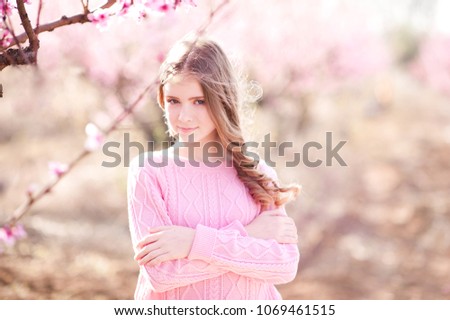 Smiling teenage girl 14-16 year old posing outdoors. Looking at camera. 20s. 