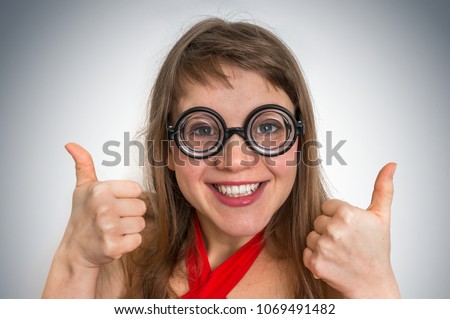 Young funny geek or nerd woman isolated on gray background