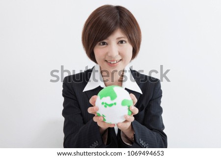 Japanese female company employee with a globe