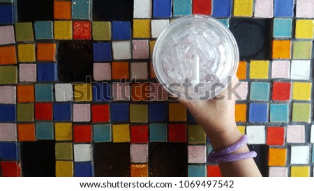 A glass of water on a table with a beautiful background