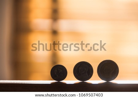 Thai coins on wood bar with silhouette style