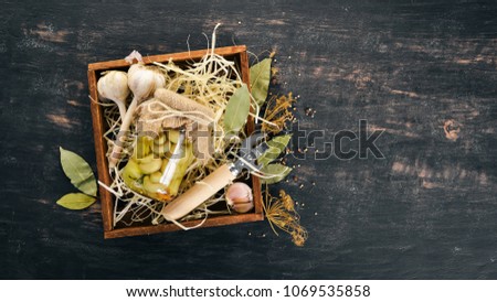 Marinated mushrooms in a jar. Stocks of food. Top view. On a wooden background. Copy space.