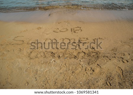 Inscription on wet sand 2018 Summer loading . Concept photo of summer vacation