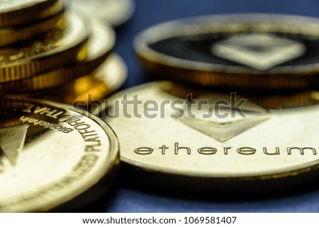 Closeup Golden virtual money Ethereum crypto currency coins stacked on a dark background