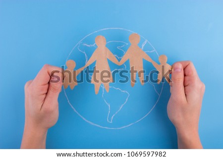 International Family day concept. Paper cut of family on the earth
