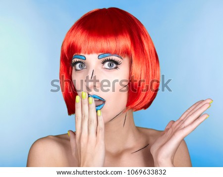 Portrait of young woman in comic pop art make-up style. Female in red wig on blue background