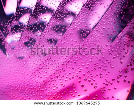 Close up of air bubble with colorful corrugated background.