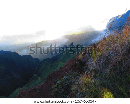 hiking mountain ridges in kauai above the clouds