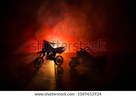 High power motorcycle chopper. Fog with backlights on background with man rider at night. Empty space. Selective focus