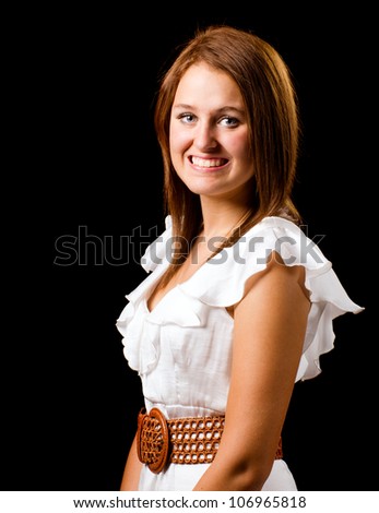 Portrait of pretty smiling happy teenage girl isolated on black