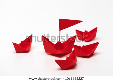 Set of origami paper boats. Leadership and business concept