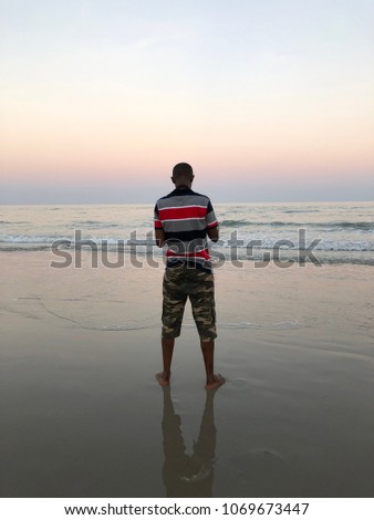 African Man relaxing on the beach.