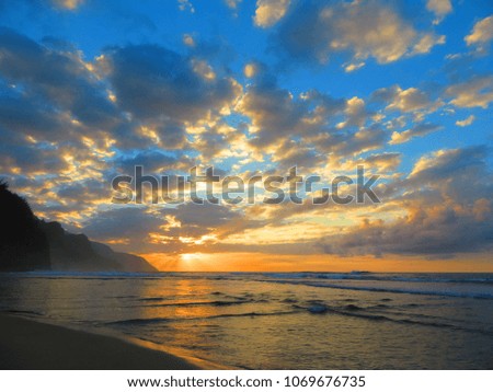 beautiful sunset on kauai beach with waves