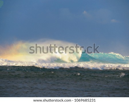 swell waves on north shore in kauai during sunset