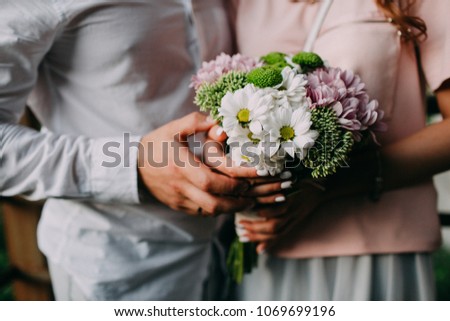 Hands with flowers, wildflowers