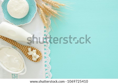Top view image of dairy products over mint wooden background. Symbols of jewish holiday - Shavuot Royalty-Free Stock Photo #1069725410