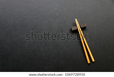 wood chopsticks on black table background