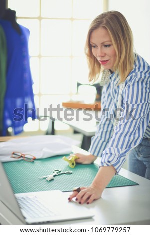 Fashion designer working on her designs in the studio