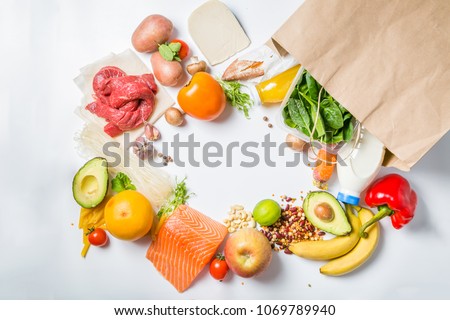 Grocery shopping concept. Balanced diet concept. Fresh foods with shopping bag on white background Royalty-Free Stock Photo #1069789940