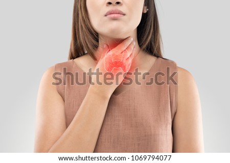 The photo of thyroid is on the human body, Women thyroid gland control. Sore throat of a people against gray background Royalty-Free Stock Photo #1069794077