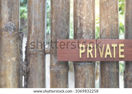 "Private" sign on bamboo wooden gate in front of the old house. Copy space for text.