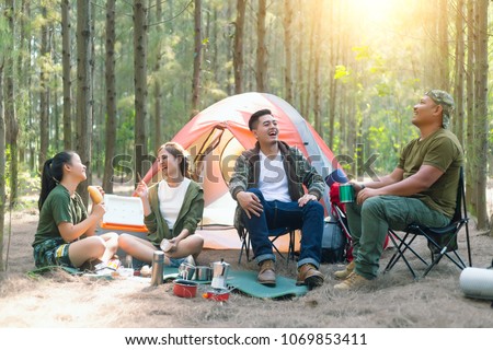 Asian couple camping in their tent on the sunny day;Vacation Concept Royalty-Free Stock Photo #1069853411