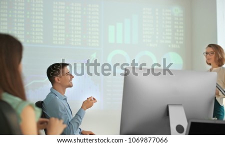 Office employees watching presentation during meeting. Forex concept