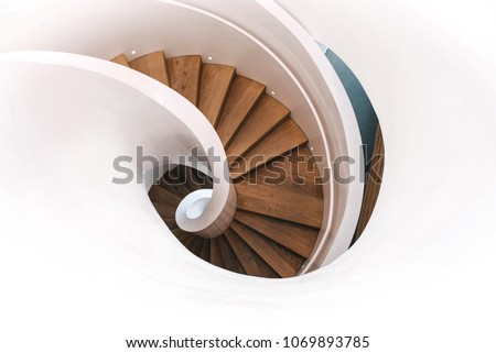 Indoor modern spiral staircase in white. Top view. Royalty-Free Stock Photo #1069893785