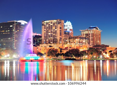 Orlando downtown skyline panorama over Lake Eola at night with urban skyscrapers, fountain and clear sky. Royalty-Free Stock Photo #106996244