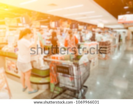 Blurred photo of cashier counter in the supermarket,Cashier at a supermarket checkout in a department store.Vintage tone.