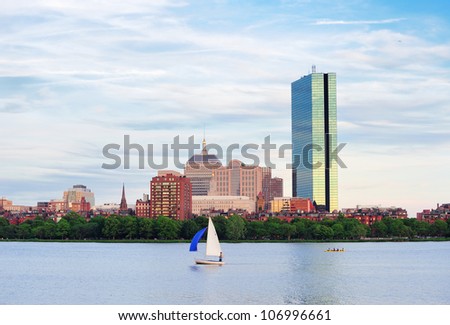 Boston Charles River with urban city skyline Hancock building and boat.