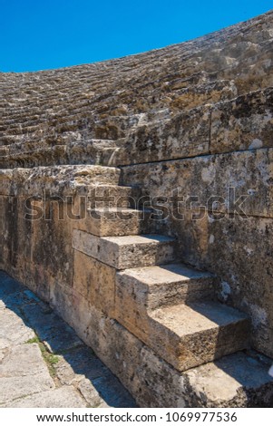 Closeup photo of steps of Roman amphitheatre in the ruins of Hierapolis, in Pamukkale, near modern turkey city Denizli, Turkey.