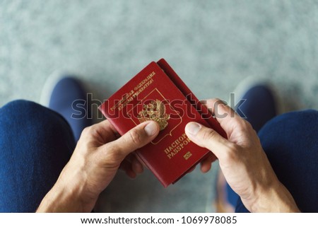 Man's hands  holding passport, top view Royalty-Free Stock Photo #1069978085