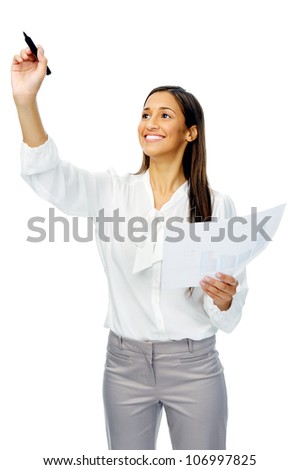 Businesswoman in long sleeved shirt holds up a felt tip marker pen to write in mid air, isolated on white
