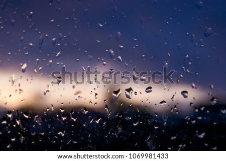 On a wet glass, drops of water are clearly visible in the evening