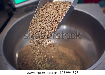 Photo of fresh coffee beans in iron scoop