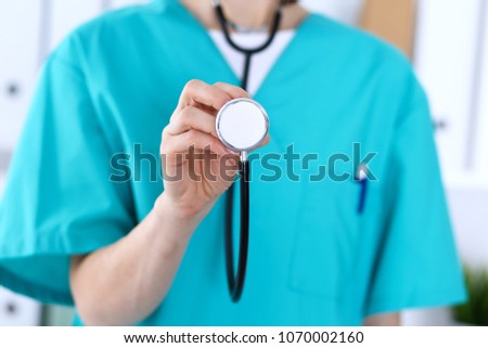 Female doctor holds stethoscope head closeup. Physicians ready to examine and help patient. Medical help and insurance in health care, best treatment and medicine concept