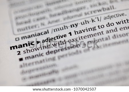 Close up to the dictionary definition of Manic Royalty-Free Stock Photo #1070042507