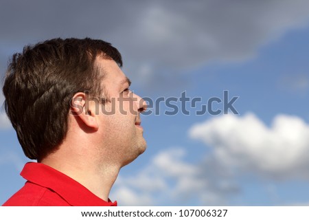 Profile of man on the sky background