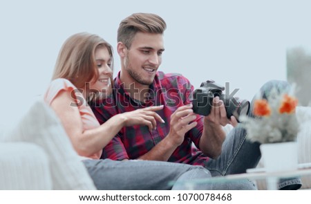 modern young couple checks the photos on the camera