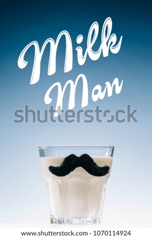 Glass of milk with mustaches and Milk man inscription isolated on blue background