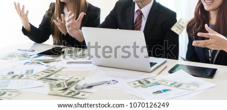 Business team parter celebrating profit by throwing money